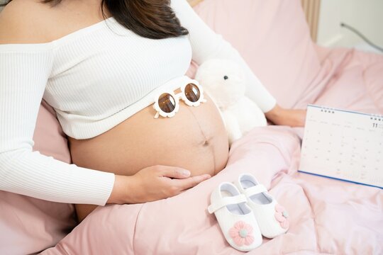 pregnant woman touches belly, Concepts of pregnancy and family. Place for text. Place for your advertisement