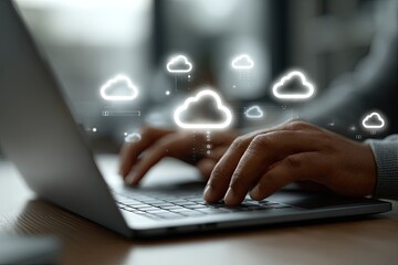 Hands typing on laptop with cloud icons overlay