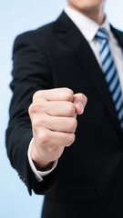 Businessman in suit pointing with clenched fist