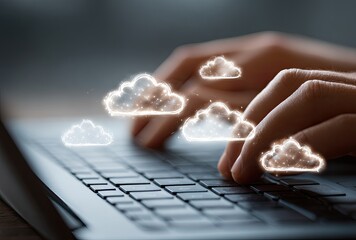 Hands typing on laptop, cloud icons overlay