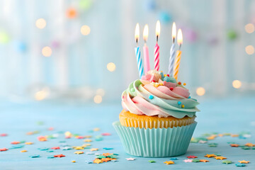 Delicious birthday cupcake on table on light background