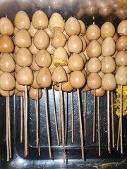 Quail egg satay is a beloved Indonesian snack, with skewered boiled quail eggs grilled or glazed in savory-sweet sauce, offering a tender and flavorful bite