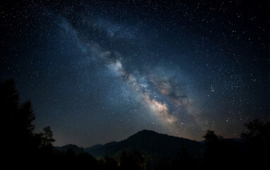 Naklejka premium The Milky Way Galaxy Shining Over Mountainous Terrain