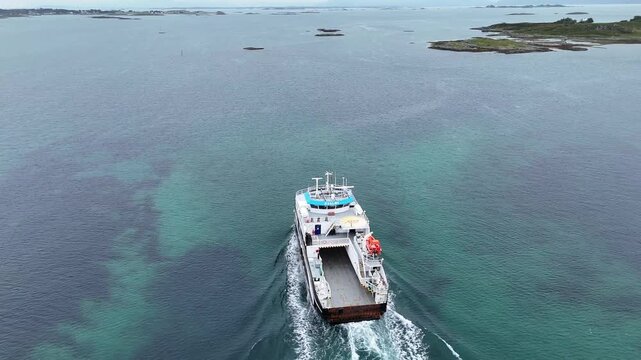 Aerial view of ferry Kvaloey moving through Sandy archipelago waters leaving wake near Ona, Norway