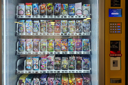 Penang, Malaysia &ndash; Sep 13, 2025: Vending machine selling trading card game booster packs including Pok&eacute;mon and other collectible series in an arcade.