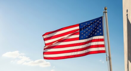 Obraz premium Vibrant american flag waving proudly against a clear blue sky on a sunny day outdoor