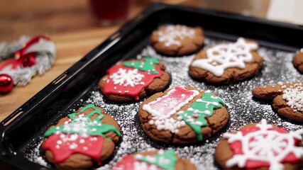 Festive gingerbread cookies decorated with icing and sprinkles, on a baking sheet - Powered by Adobe