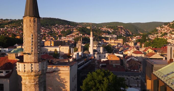 Flying Through Sarajevo Skyline At Sunset With Gazi Husrev-beg Mosque And Historic Buildings In View. drone shot