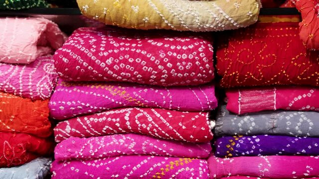 rajasthani traditional Bandhani saree with detailed weaving stacked at retails store for sale