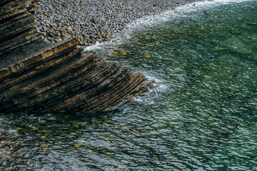 Stratified Rock Formations And Pebble Beach On Basque Coastline Spain. Layered sedimentary cliffs,...