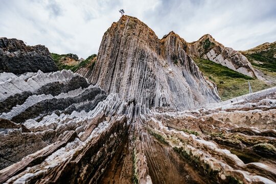 Flysch Rock Formations With Vertical Geological Strata On Zumaia, Basque Coast Spain. Ancient sedimentary layers, coastal cliffs, erosion patterns