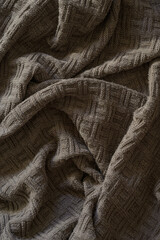 a knitted blanket lies comfortably on the sofa