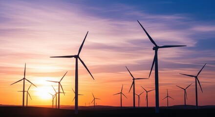 Fototapeta premium Wind turbines silhouette at sunset renewable energy