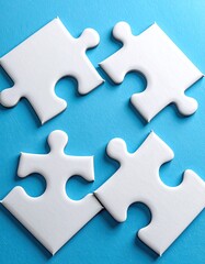 Fototapeta premium Four white puzzle pieces on a light-blue surface