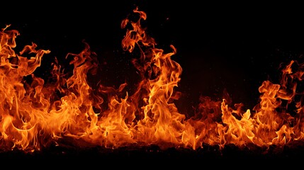 Fototapeta premium Intense and vibrant flames illuminate a dark background in this image
