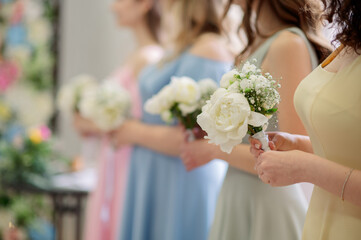 Bridesmaids carrying elegant white peony bouquets, highlighting wedding ceremony's romantic and floral elegance moments