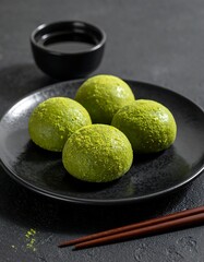 Matcha mochi on dark plate