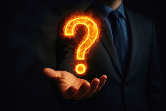Man in a suit holding a burning question mark symbol in his palm with a dark background fire flame - Powered by Adobe