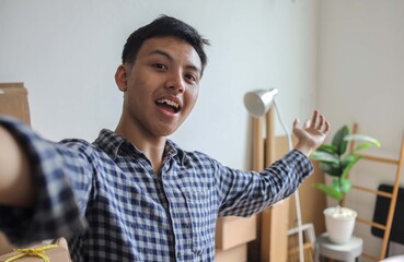 Fototapeta premium Camera POV of Cheerful Man Taking a Self Portrait in His New Home