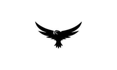 Fototapeta premium A majestic black eagle with outstretched wings in silhouette against a clean white background, symbolizing freedom and power