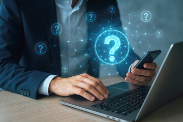 Businessman using laptop and smartphone with glowing question mark network 