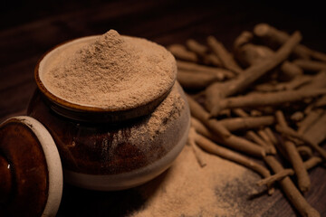 Ashwagandha herbal powder with raw ashwagandha roots near