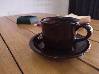 Black Coffee and White Bread on Wooden Table