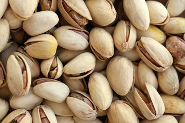 Many tasty unpeeled pistachios top view flat lay background pattern