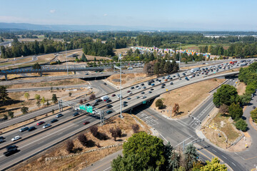 Aerial drone picture of Interstate 5 freeway traffic near Portland, Oregon, with northbound vehicles traveling toward Vancouver, Washington, near I-5 bridge, showing congestion and transport flow