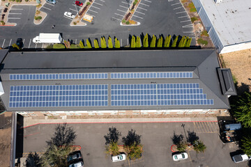Modern hotel building in Portland, Oregon with rooftop solar panels captured in 4K aerial drone footage, highlighting renewable energy, green technology, clean power, sustainable architecture design