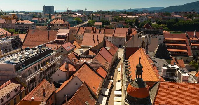 Maribor, Slovenia - August 09, 2025: View of Maribor city from Stolna župnija Maribor tower on sunny summer day. Timelapse, zoom in transition.