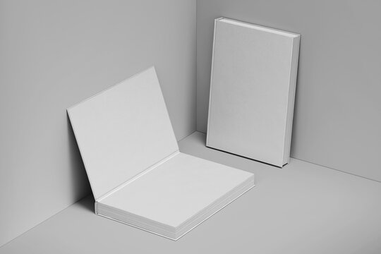 two blank 6x9 inch hardcover thick book realistic clay mockup template leaning in grey background 3d render illustration