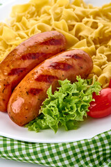 Sausage with Noodles, Tomato, Lettuce on Plate
