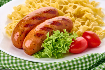 Sausage Pasta Dish with Lettuce Tomato, on Plate