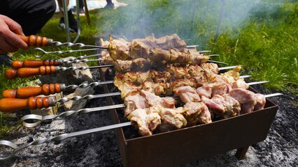 Shashlik is being grilled on the barbecue.