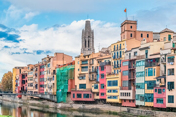 Girona cityscape along the Onyar River, Catalonia, Spain. Colorful houses, a bridge, and the...