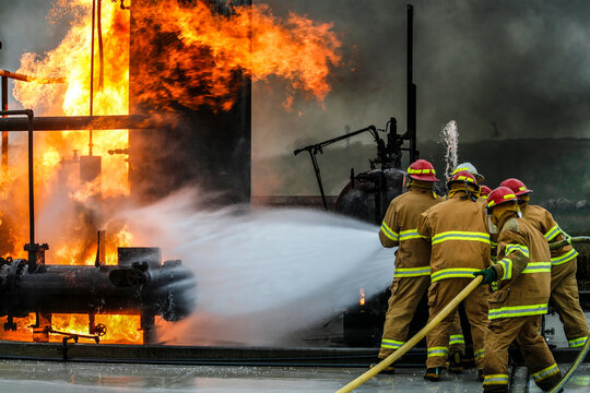 Firefighters practice in a refinery