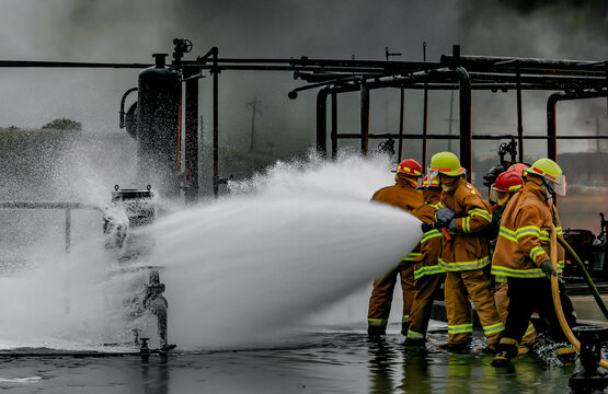 Firefighters practice in a refinery