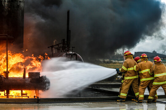 Firefighters practice in a refinery