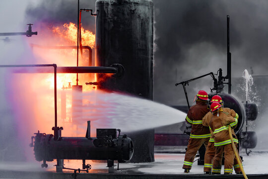 Firefighters practice in a refinery