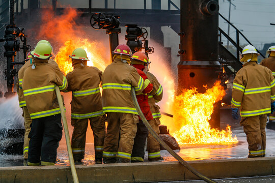 Firefighters practice in a refinery