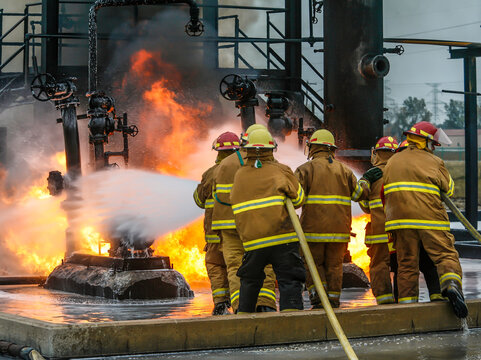 Firefighters practice in a refinery