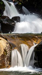 Cascading waterfall over dark rocks