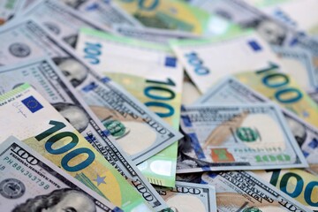 Big pile of Euro and USD banknotes. Many european and united states dollars