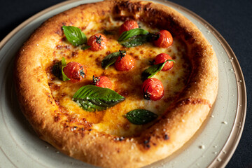 Margherita Pizza Delight: A close-up shot of a freshly baked margherita pizza, its golden crust glistening under the warm light, adorned with vibrant red cherry tomatoes and fresh basil leaves.