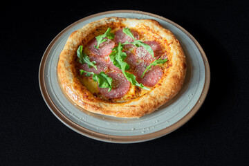 Artisan Pizza Delight: A tantalizing view of an artisan pizza on a rustic plate, featuring a delectable array of toppings and a golden crust, promising an experience for food lovers.