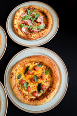 Artisan Pizza Delight: Overhead view of artisan pizzas showcasing fresh ingredients, inviting the viewer to savor the homemade flavor