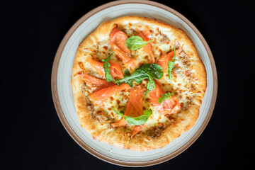 Gourmet Pizza: The tantalizing overhead shot showcases a beautifully crafted pizza, its golden crust and savory toppings, a true culinary delight.
