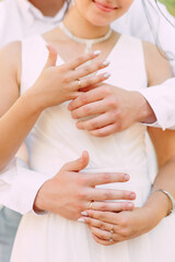 The bride and groom show wedding rings, the hands of two lovers