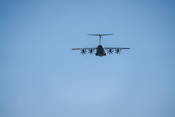 RAF Airbus C.1 A400M Atlas military transport aircraft in flight on a low-level cargo drop run, blue sky